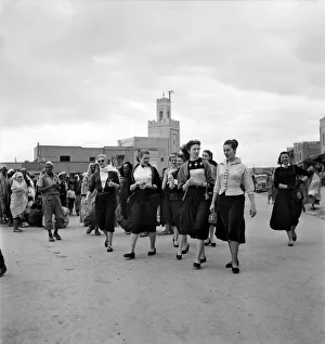 Arabic Prints: Group of French actresses walk through the streets and market square in Marrakech