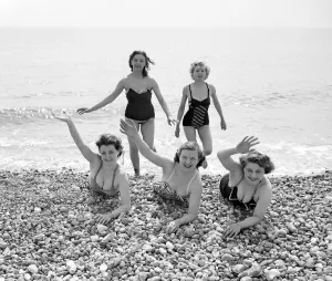Swimsuit Prints: A group of friends waving during a visit to the beach in Springtime Britain Circa