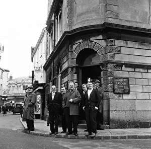 A group of men standing outside the Ministry of Labour on the High Street, Barnstaple