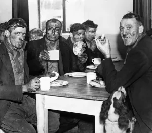 Dinner Prints: A group of miners enjoying a meal after the opening of a pithead canteen at Isabella Pit