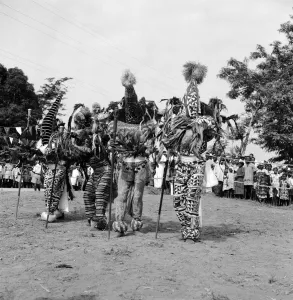 A group of Nigerian dancers who are performing in traditional costume for Queen Elizabeth