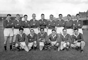 Group pic of Wigan players before training in their cup strip of plain red jerseys