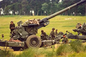 Camouflage Prints: The gunners of the Royal Artillery make the last minute adjustments before firing