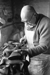Gunsmith making a stock for a shotgun in Birminghams Gun Quarter. Circa 1973