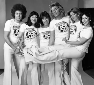 Guys N Dolls pop group wearing Daily Mirror Pop Club T-shirts 29th January 1976