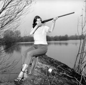 Gwendolen Tulley poses with her rifle as she enjoys a shooting holiday, 1956
