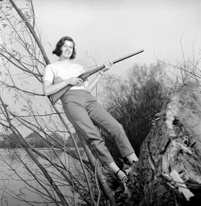 00845 Prints: Gwendolen Tulley poses with her rifle as she enjoys a shooting holiday, 1956
