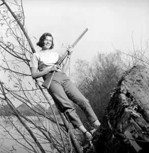 00845 Prints: Gwendolen Tulley poses with her rifle as she enjoys a shooting holiday, 1956