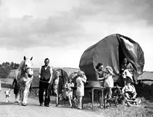 Caravans Prints: A gypsie caravan parked in a field is home to some of the evacuees who have fled London