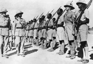 Haile Selassie inspecting Ethiopian troops together with British Officers attached to