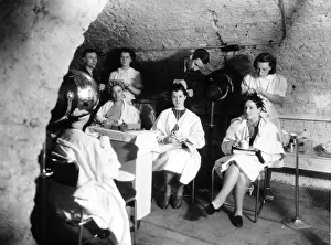 00153 Prints: Hairdressers carry on working in an underground air raid shelter during WW2