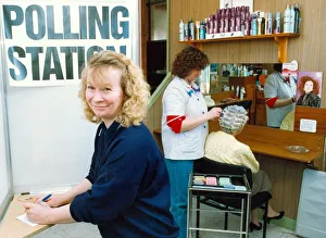 00083 Prints: One of the hairdressers casting her vote at the polling station in her salon while staff