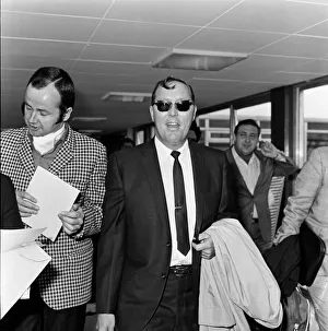 Bill Haley arrives at London Airport. Leather clad rockers from his fans club were