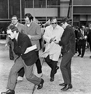 Bill Haley arrives at London Airport. Leather clad rockers from his fans club were