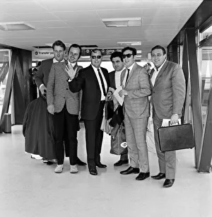 Bill Haley arrives at London Airport. Leather clad rockers from his fans club were