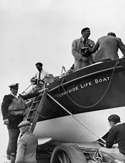 On its half tracked carriage, the Ferryside Lifeboat runs down the slipway