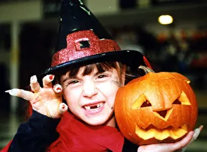 Witch Prints: Halloween - little witch Bethan Parker (aged 6) of Rhydyfelin with her Halloween pumpkin