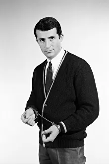 Handcuffs feature. Model Henry Fern in cardigan wearing handcuffs. Circa 1964