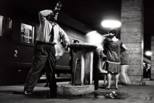 Bottle Prints: A happy man leans against the drinking fountain at Naples Station - June 1962