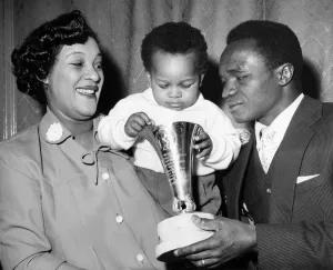 00059 Prints: A happy reunion for Hogan Kid'Bassey with his wife and 19 months old son