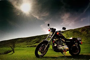 Landscape Features Prints: Harley Davidson motorbike sitting in field June 1998 sun shining dark skies