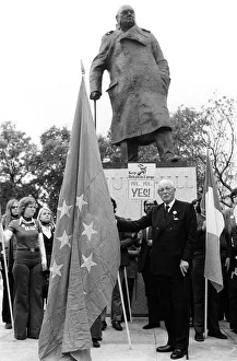 European Union Prints: Harold MacMillan March 1975 holding the European flag under the statue of Sir Winston