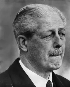 Harold MacMillan Prime Minister MP standing outside the door of the Royal Lounge