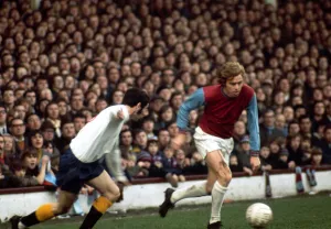 Harry Redknapp of West Ham United in a chase for the ball with John Robson of Derby