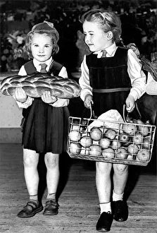 Harvest Festival. Two of the children arriving with harvest festival gifts