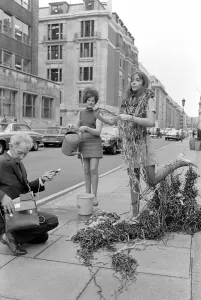 Harvey Morris recording Autumn leaves by a fountain with the aid of 22 year old Jane