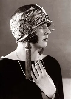 Hat fashion - April 1924 Woman wearing elaborate hat with tassles