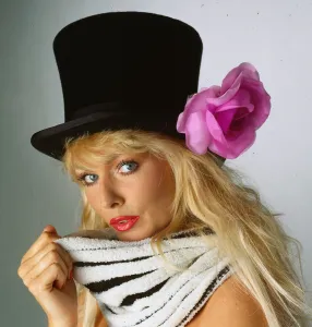 Striped Prints: Hat Fashion model wears black top hat with lilac flower April 1990