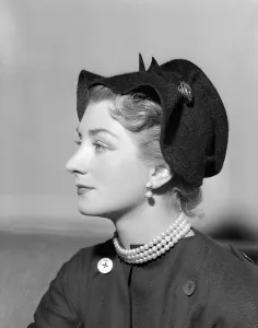 00197 Prints: Hat Fashion by Norman Hartnell Wearing a black hat with rim deatil