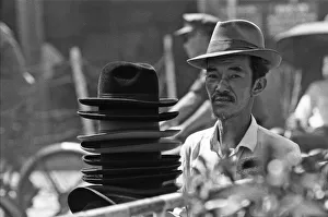 Hat seller at the flower market in Saigon on the eve of the Tet celebrations