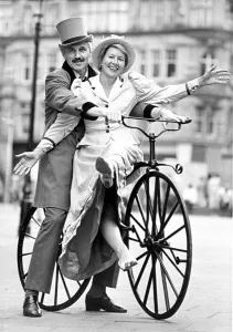 00078 Prints: Hazel Hesse and John silkstone try out a vintage bicycle at the launch of their charity