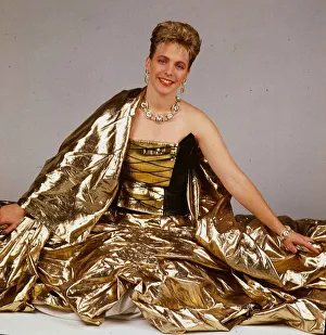 Hazel Irvine TV presenter September 1988 wearing gold evenign sress sitting on floor