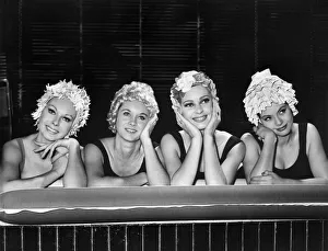 Four heads with a single thought, girls wearing summer swimwear. October 1962 P007855