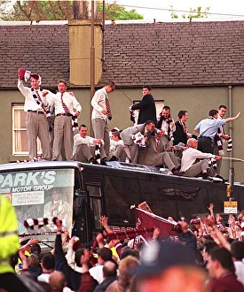 Hearts Prints: Heart of Midlothian football players waves to fans who have lined the streets of