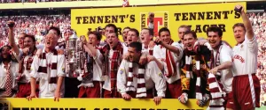 Team Prints: Heart of Midlothian footballers celebrate with the Scottish Cup trophy after defeating