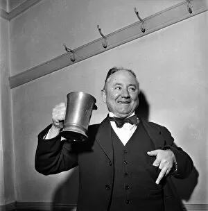 00021 Collection: Hector Hughes, Q. C. Labour M. P. for Aberdeen North enjoys a tankard of Inn Coope beer