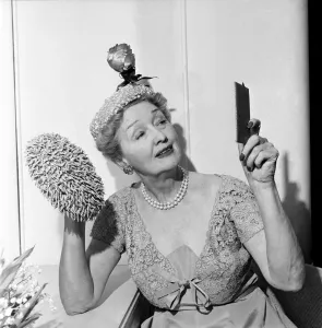 Hedda Hopper who is going to present to the Queen two of her fantastic hats