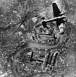 Plane Prints: A Heinkel 111 bomber aircraft of the German Luftwaffe flies over Tower Bridge