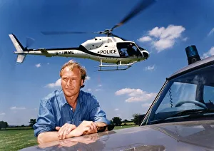 A helicoper hovers above the head of actor Nigel Le Vaillant in a field at Studley Grange