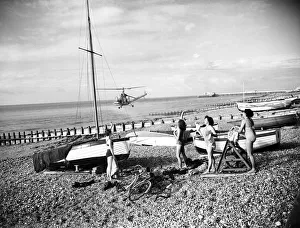 West Sussex Prints: A helicopter sprays insecticide in an attempt to kill off sand hoppers, on Worthing beach