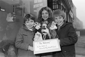 00523 Prints: Helme Junior School pupils arranging their Nativity scene in the window of a Meltham