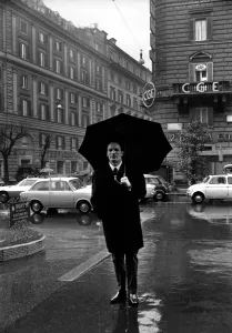 Henry Cooper in Italy: Henry Cooper pictured in the rain on the Via Veneto