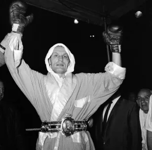 Henry Cooper jubilantly shows his Lonsdale belt after his boxing triumph over Johnny