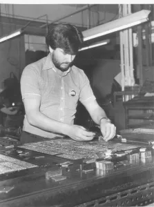 Herald Express compositor using the old hot metal system of printing at the paper