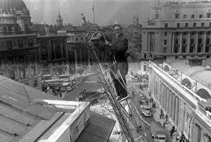 01444 Prints: Herbert Morrison, Minister of Home Security, up a ladder, London. 1942