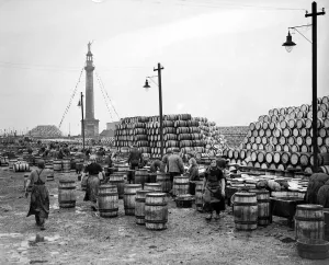 Dockyard Prints: Herring girls unloading barrels of herring at the docks in Great Yarmouth Circa